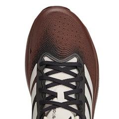 Close-up of adidas SFTM Supernova Rise 3 running shoes in auburn color, showing the textured upper and sleek design.